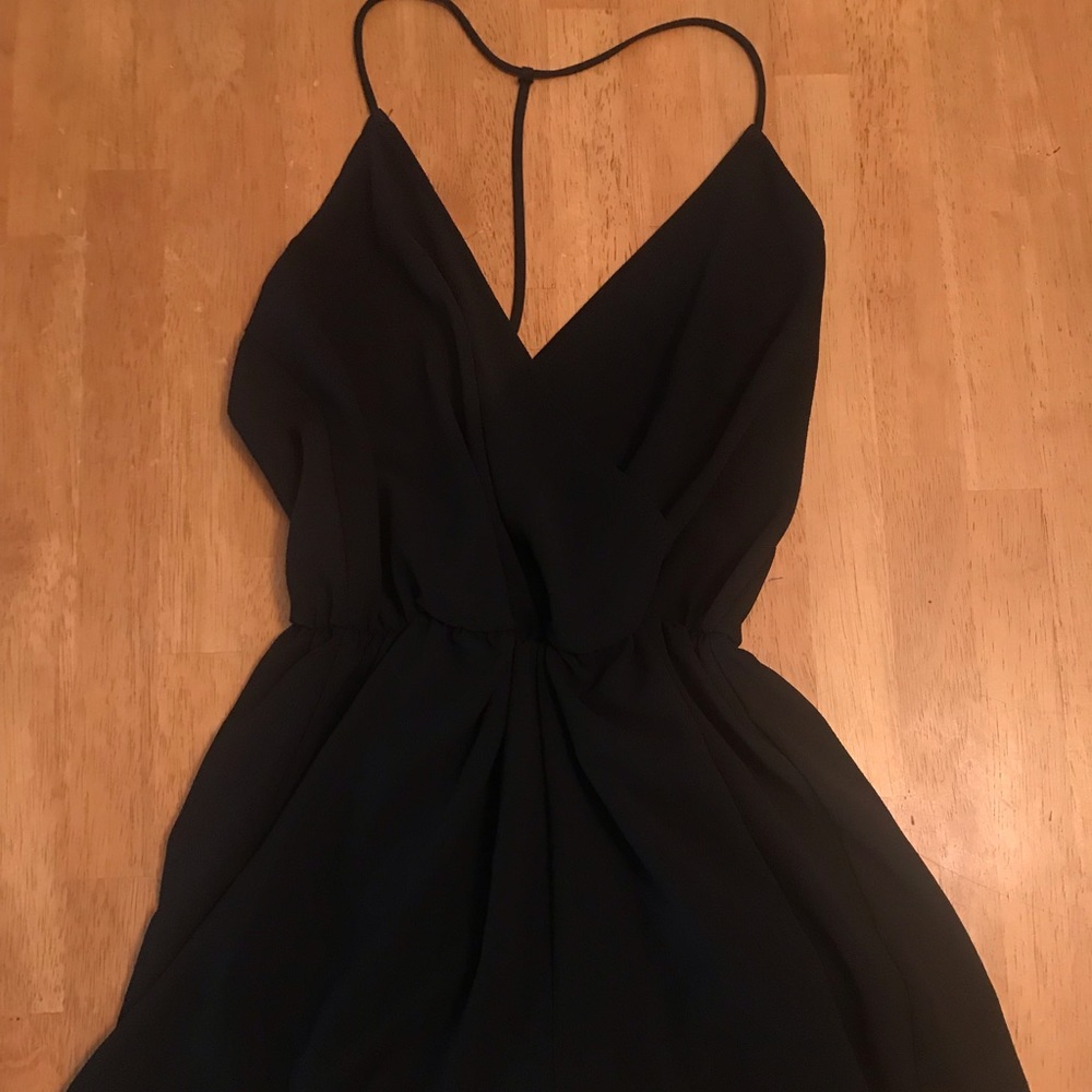 Black romper with unique back. Size small
